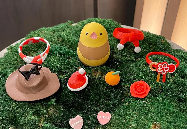Bird figure surrounded by swappable accessories on moss